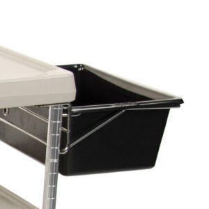 Close-up of a black Metro MYUB2 myCart Series Utility Bin and Holder for MY2030 attached to a white metal shelf with a wire frame. A corner of a white tabletop is visible above the bin, set against a plain white background.