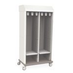 The Metro SXRD83MCATHTD Starsys Tambour Door Mobile Catheter Storage Cabinet in white is a tall, double-wide mobile unit with two vertical compartments featuring gray horizontal tray/shelf slots, a flat top, and four wheels for easy mobility.