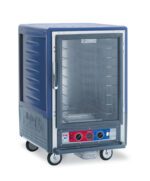 The Metro C535-CLFC-4-BU C5 3 Series insulated holding/proofing cabinet, in blue and gray, features a full-length clear door, fixed wire slides, and showcases metal shelves. It includes a control panel with red and blue dials at the bottom and is mounted on wheels for easy mobility.