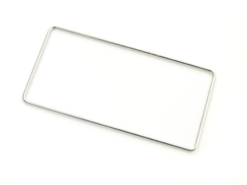 cxfc6uwc3y40quo4si5tmqc58x4hi15e.jpg Displayed on a plain white background, a silver, rectangular metal frame resembles the minimalist elegance of the Metro MS-RING PrepMate Magic Ring. With thin rounded corners, it appears crafted for a license plate, exuding simplicity and style.