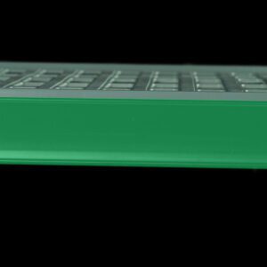 A close-up of a computer keyboard highlights a Metro CSM6-GQ color shelf marker for Super Erecta Pro and MetroMax Q industrial shelving in vibrant green, contrasting against typical grey keys on a black background.