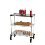 The Metro CR1430DTOSC Drive-Thru Order Staging Cart has three shelves: the top holds four red cups with straws, the middle is stacked with pizza boxes, and smaller boxes are below. Its designed for easy mobility with four sturdy wheels.