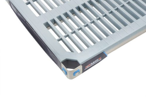 Close-up of a MetroMax i MX1836G Plastic Industrial Shelf with Grid Mat, 18 x 36, in gray and blue slats, featuring branded labels and plastic end caps that display precise craftsmanship and modern design.