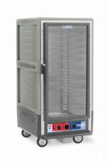 The Metro C537-MXFC-U-GY C5 3 Series is a 3/4 height insulated heated holding/proofing cabinet featuring a full-length clear door, universal wire slides, and a bottom control panel. It operates on 220-240V in a professional kitchen and has wheels for easy mobility.