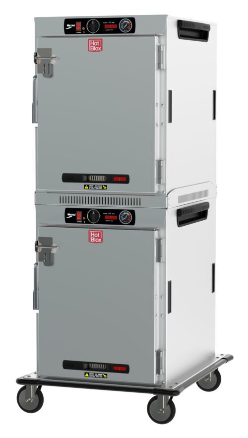 The Metro HBCW16-AS-T HotBlox features a dual-cavity design with solid doors and analog controls. It includes (2X) 120V, 60Hz, 875W power, NEMA 5-15P plugs, a latch and temperature gauge on each door, mounted on wheels for mobility.