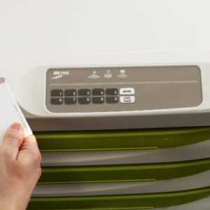 A Metro FLX430PLF Flexline Low Frequency Proximity Cart Reader is used near a lockable cabinet with an electronic keypad featuring six gray buttons (1-6) and options for entering, locking, and clearing, ensuring secure access above the cabinets green drawers.