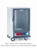 The Metro C515-CFC-LA C5 1 Series, a 1/2 height holding/proofing cabinet, features lip load aluminum slides, transparent front door, vibrant red and blue panel with control knobs at the base. It operates on 120V and is mounted on wheels.