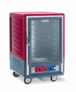 A red Metro C535-CXFC-4A C5 3 Series Insulated Holding/Proofing Cabinet on wheels features a full-length clear door, metal racks with fixed wire slides, and temperature control knobs. It operates at 220-240V, 50/60Hz, and 1681-2000W.