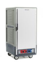 The Metro C537-CLFS-4-GY is a large, rectangular gray mobile food warmer with a 3/4 height full-length solid door, black handle, control panel with dials at the bottom, operates on 120V, and is on wheels for easy transport.