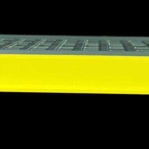 A gray metal shelf showcases the Metro CSM6-YQ Color Shelf Marker for Super Erecta Pro and MetroMax Q Industrial Plastic Shelving, a vibrant yellow label holder, set against a sleek black background.