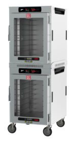 The Metro HBCW16-DC-M HotBlox Cabinet has transparent doors, sturdy metal frames, and a digital touchscreen controller for precise 60Hz settings. It features wheels for easy mobility and the brand logo on top. Model: (2X) 120V, 60Hz, 875W, NEMA 5-15P.