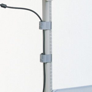 A close-up shows a vertical metal pole with two Metro TMX Cable/Tube Management Clips holding black cables, set against a plain white background with a hint of gray surface in the bottom right corner.