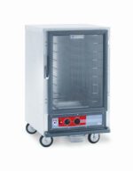 The Metro C515-HFC-4A C5 1 Series is a 2000W, 120V, half-height holding cabinet featuring a glass door, metal exterior, and four caster wheels. It includes fixed wire slides with multiple shelves and has a bottom control panel with temperature dial and digital display.