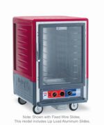 The Metro C535-MFC-L is a red, 1/2 height insulated moisture heated cabinet with a full-length clear door and lip load aluminum slides. It has bottom control knobs, wheels for mobility, and runs on 120V, 60Hz. Text reads: Note: Shown with Fixed Wire Slides. Total power is 2000W.
