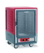 The Metro C535-HLFC-UA C5 3 Series Insulated Holding Cabinet is a 1/2 height, red unit with a full-length clear door, universal wire slides, and operates at 120V. It features wheels for mobility and has a control panel with knobs and a digital display at the bottom front.