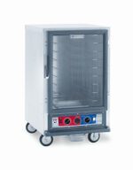 The Metro C515-CFC-4 C5 1 Series is a 1/2 height stainless steel holding/proofing cabinet on wheels with fixed wire slides, featuring a clear front door and a bottom control panel with red and blue sections, two knobs, and a display. It operates efficiently at 120V, 60Hz, 2000W.