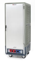 The Metro C539-CLFS-U-GYA C5 Insulated Holding/Proofing Cabinet, with universal wire slides for versatile storage, is a large gray mobile unit featuring a left-side door handle, control panel with red and blue dials, and side ventilation slits. (120V, 60Hz, 1440W).