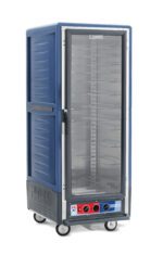 The Metro C539-MFC-U-BU C5 3 Series Cabinet, full-height with a clear door and blue finish, includes bottom control knobs, shelves, wheels for mobility, and universal wire slides. Its insulated moisture heated design at 120V ensures versatile food storage.