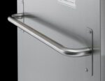 Mounted on a silver metal surface, a stainless steel door features the sleek Metro C5-HANDLE Rear Push Handle for C5 9, 8, and 6 Series Cabinets. A small rectangular label sits above the handle. The dark background enhances its sophisticated finish.