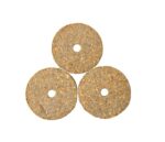 Three speckled coir disks resembling Justrite Gasket fittings are stacked in a triangle with a central hole, set elegantly against a stark white background.