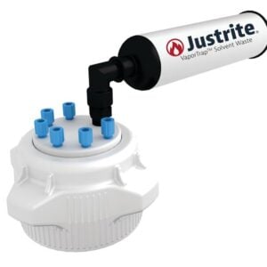 A white Justrite Cap, featuring multiple blue nozzles, connects to a black hose attached to a cylindrical device labeled Justrite VaporTrap Solvent Waste on a white backdrop. The Justrite Cap (PP, 83mm) fits 6X 1/8 OD tubing for efficient solvent management.