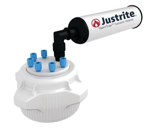 A white Justrite Cap, featuring multiple blue nozzles, connects to a black hose attached to a cylindrical device labeled Justrite VaporTrap Solvent Waste on a white backdrop. The Justrite Cap (PP, 83mm) fits 6X 1/8 OD tubing for efficient solvent management.
