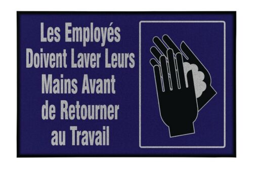 The sign, with a dark blue backdrop and white text, reads Les Employés Doivent Laver Leurs Mains Avant de Retourner au Travail, featuring a hand-washing icon akin to the Justrite Mat,194 Fren Employee Wash 4X6 for workplace hygiene.