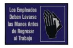 A Justrite Mat, 194 Span Employee Wash 4X6, is placed beneath a sign in Spanish that says Los Empleados Deben Lavarse las Manos Antes de Regresar al Trabajo with a handwashing illustration against a dark blue background.