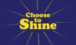 Bold yellow text on a blue background reads Choose to Shine, with yellow lines radiating like sunbeams, capturing the optimistic spirit of the Justrite Mat,195 Choose To Shine 3X5 Bu design.