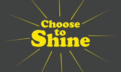 Centered on a dark background, yellow text reading Choose to Shine is surrounded by radiating yellow lines, creating a sunburst effect similar to the Justrite Mat, 195 Choose To Shine 3X5 Ch.