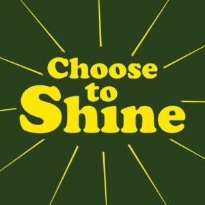 The image features the Choose to Shine message in bold, yellow letters on a Justrite Mat, 195 Choose To Shine 4X6 Gn, with a dark green backdrop. Radiating lines symbolize the collections positive spirit.
