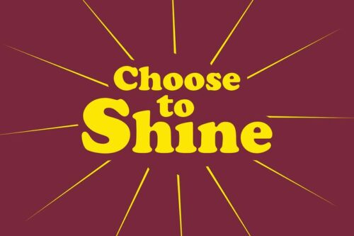 Yellow text stating Choose to Shine is enhanced by radiant lines on a maroon background, capturing the vibrant style of the Justrite Mat, 195 Choose To Shine 4X6 Rd.