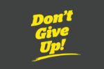 Bold yellow text on a dark gray background reads Dont Give Up! with an underline, echoing the inspiring message found on a Justrite Mat, 195 DonT Give Up 4X6 Ch.