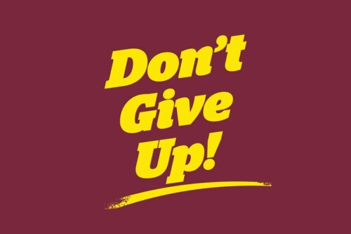 The Justrite Mat features bold yellow text on a maroon background reading Dont Give Up! with a yellow underline, echoing the vibrant motivation of the 195 Dont Give Up 4X6 Rd design.