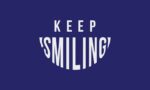 On a vibrant blue background, KEEP SMILING appears with SMILING in a cheerful, curved font. This uplifting message mirrors the positive vibes of the 3X5 Justrite Mat, 195 Keep Smiling Bu design.