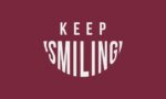 KEEP SMILING text appears on a maroon background, with SMILING creatively styled as a smile, echoing the vibrant appeal of the Justrite Mat at 195 Keep Smiling 3X5 Rd.