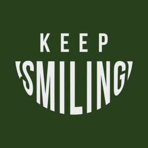 Text on the 4X6 dark green Justrite Mat reads Keep Smiling in white capital letters, with Smiling curved like a smile, capturing an encouraging essence.