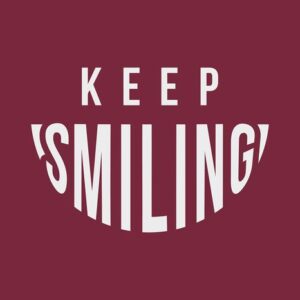 Text on a burgundy background reads KEEP SMILING, with SMILING curved upwards like a smile, capturing the cheerful essence of the Justrite Mat, 195 Keep Smiling 4X6 Rd.