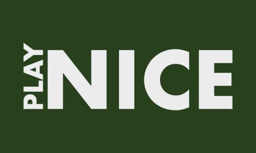 The Justrite Mat, 195 Play Nice 3X5 Gn, boasts a bold design with PLAY NICE in white text on a dark green background. The word PLAY is vertically aligned next to NICE, creating a striking visual.