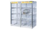The Justrite Cylinder Locker, 16 Horizontal, is designed with durable diamond-pattern mesh for storing up to 16 cylinders. It includes yellow signs stating No Smoking, Full Cylinders, Empty Cylinders, and Flammable Keep Fire Away. The cage features empty shelves and a chain closure.