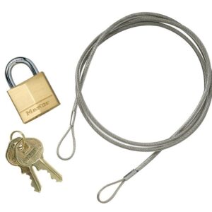 A photo shows a coiled steel cable with looped ends from the Justrite Anchoring Cable Kit, featuring a Master-branded brass padlock and two brass keys on a ring.
