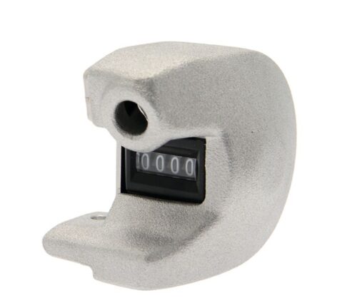 The Justrite Counter, a Dualcomp-Supr model from Aerosolv, is a sleek mechanical device with a curved metallic silver casing. Its black display shows 0000, featuring a circular hole at the top and an open section on the left side, blending functionality with style.