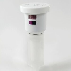 The white cylindrical Justrite Filter, resembling an Aerslv, has a translucent lower chamber and a top compartment with small pink beads. Its rectangular window displays labels in a Clr Combo scale, all against a plain white background.