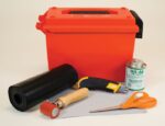 The Justrite Repair Kit, Mod PVC W/O Heatgun, includes an orange storage box, black roll of material, HH-66 Vinyl Cement can, utility knife, red roller, gray fabric sheet, and orange scissors—ideal for projects without a heat gun.