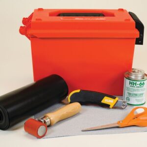 The Justrite Repair Kit, Mod PVC W/O Heatgun, includes an orange storage box, black roll of material, HH-66 Vinyl Cement can, utility knife, red roller, gray fabric sheet, and orange scissors—ideal for projects without a heat gun.