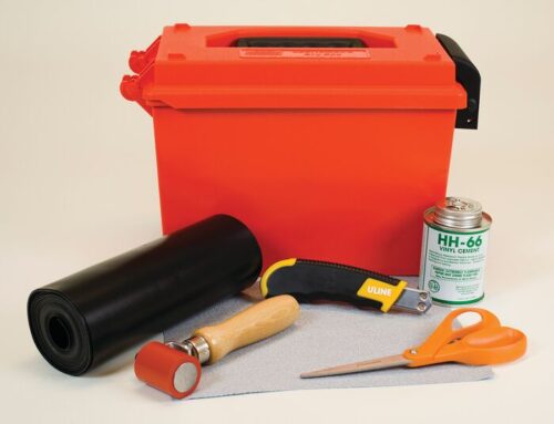 The Justrite Repair Kit, Mod PVC W/O Heatgun, includes an orange storage box, black roll of material, HH-66 Vinyl Cement can, utility knife, red roller, gray fabric sheet, and orange scissors—ideal for projects without a heat gun.