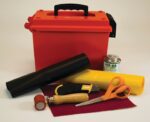 A red toolbox with a black handle is surrounded by a PVC Justrite Repair Kit without a heatgun, including black and yellow fabric, HH-66 can, utility knife, orange scissors, wooden-handled tool with red top, and red sandpaper.