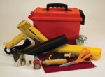A collection of vinyl crafting tools includes a red toolbox, yellow heat gun, and the Justrite Repair Kit with PVC coated fabric. It features adhesive cans, cutting tools, scissors, a tube, and PVC fabric for your projects.