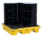 Four black industrial barrels sit on a bright yellow Justrite Pallet, 4 Drum Sq, Eco Yel. This design features a grated surface to catch leaks, ensuring safety and reliability, with Justrite prominently displayed.