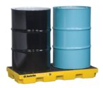 Two large barrels, one black and one blue, sit side by side on a yellow Justrite Accum Ctr, 2 Drum, Ecopoly Yel spill containment pallet with a grid pattern designed to prevent spills or leaks.